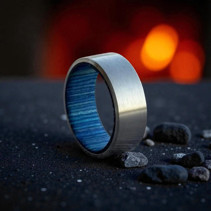 Titanium ring with matte silver exterior and blue whiskey barrel wood interior
