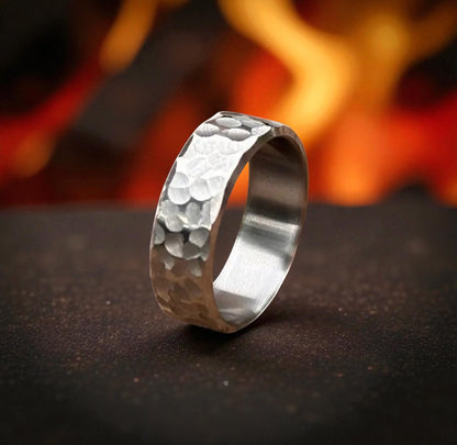 Titanium wedding ring featuring a unique hammered texture, showcasing a modern and rugged design.