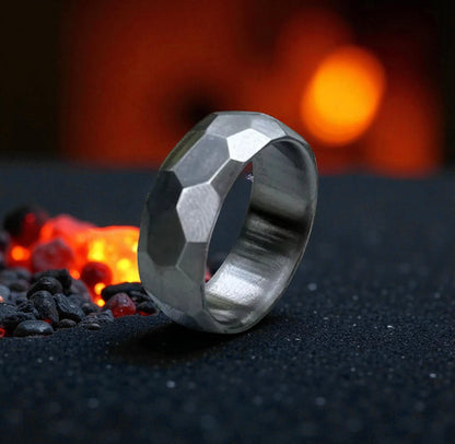  A ring set against a black backdrop, surrounded by vibrant flames, highlighting its intricate design.
