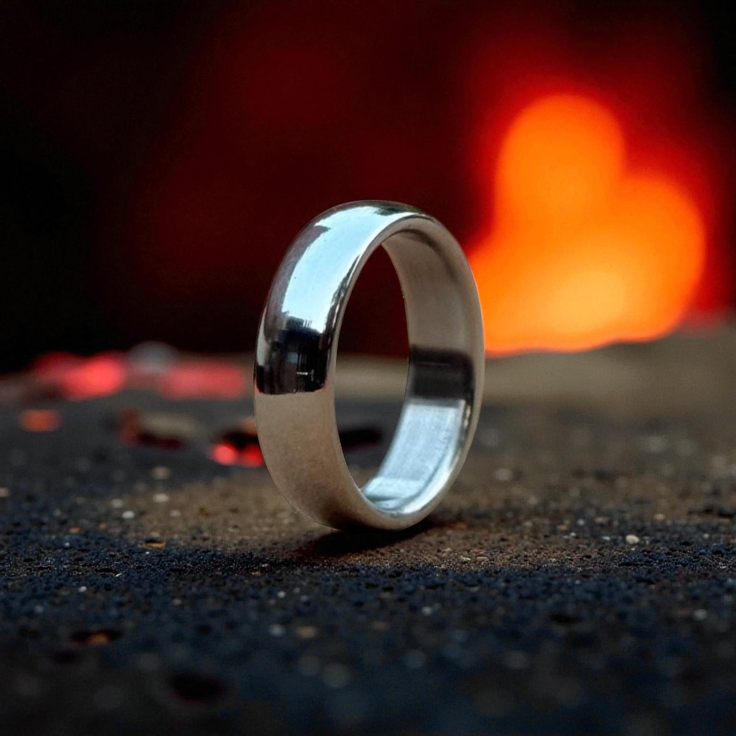 Close-up of shiny titanium ring with curved dome finish and mirror polish