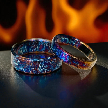 Pair of titanium rings with blue and bronze electric patterns