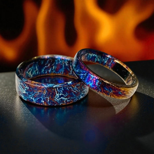 Pair of titanium rings with blue and bronze electric patterns