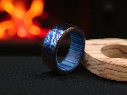 Toxic titanium blue whiskey barrel ring with a prop and light background