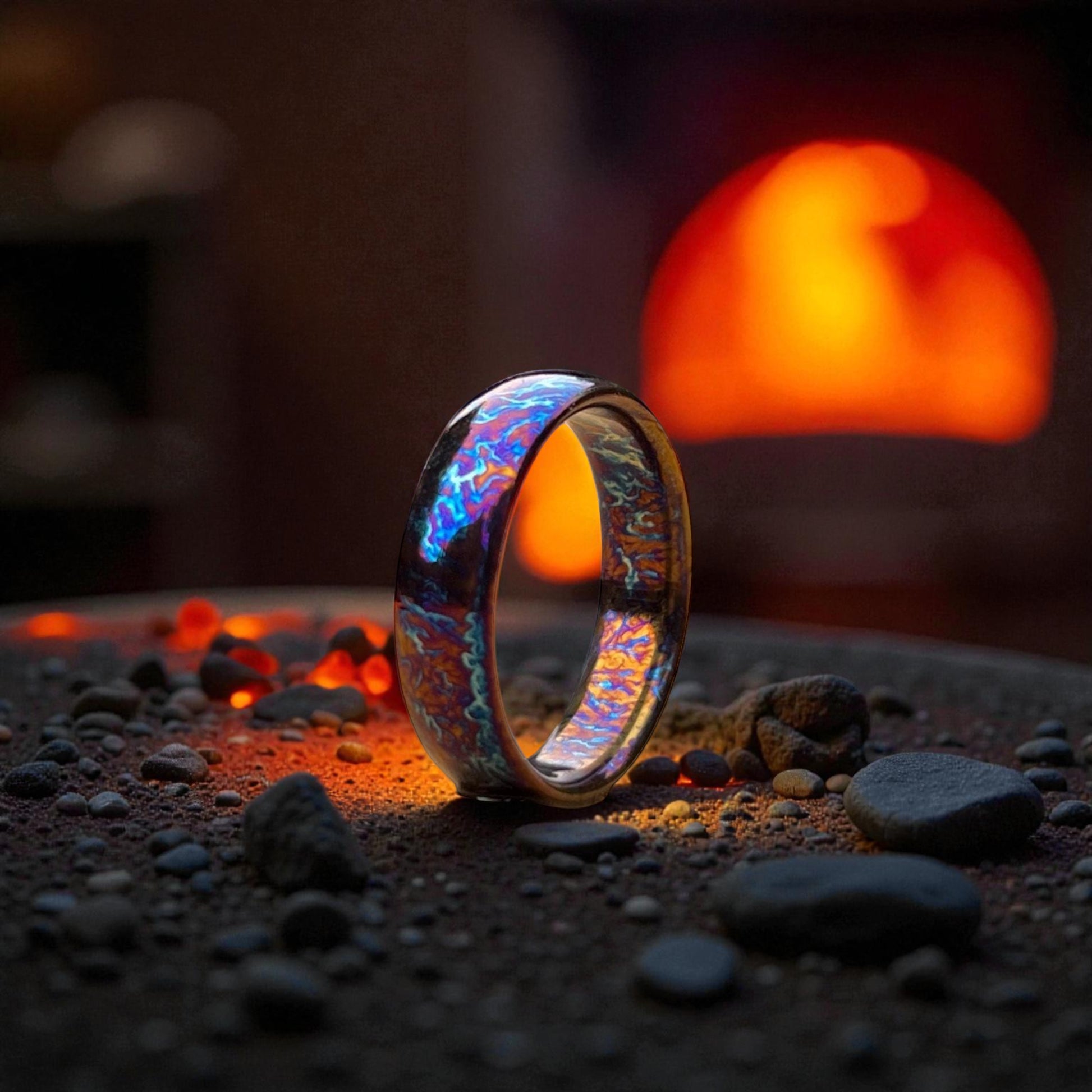 Polished titanium dome ring glowing with fire-toned reflection