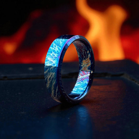 Close-up of polished titanium ring with electric blue and bronze pattern