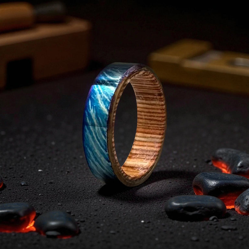 Titanium ring with blue lightning pattern and whiskey barrel wood interior